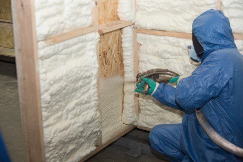 contractor applying spray foam insulation